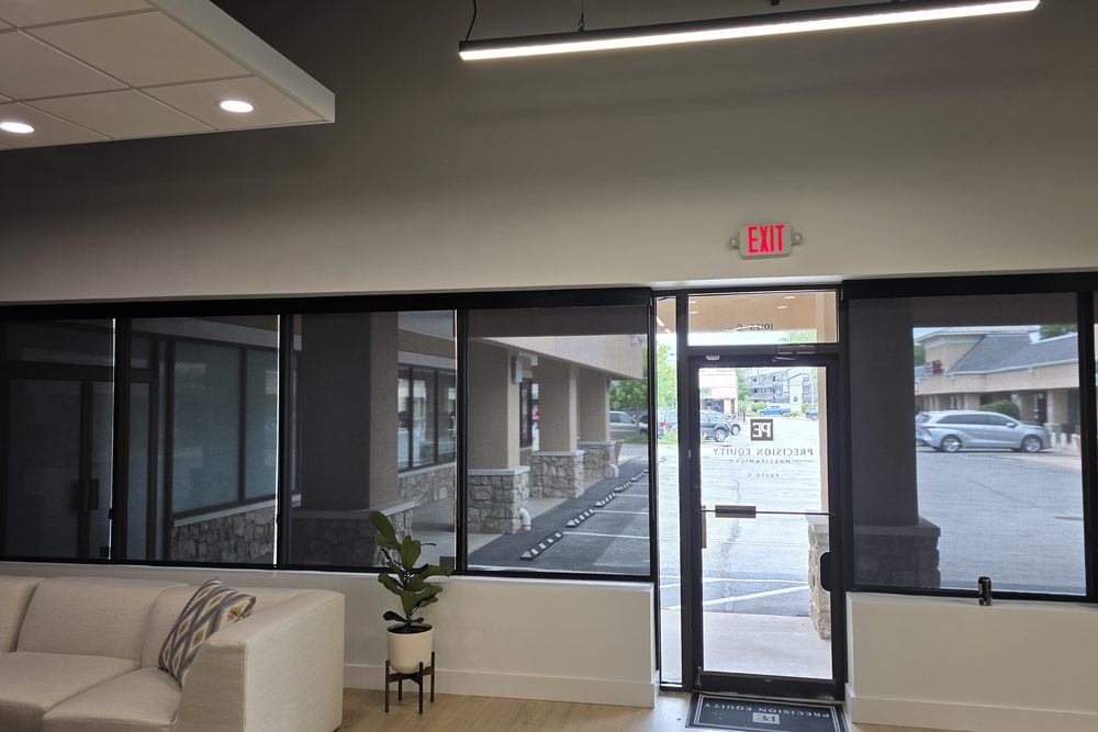 Solar roller shades and window tinting in a commercial office lobby